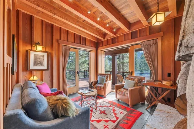 a living room with furniture and a floor to ceiling window