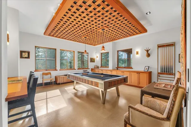 a living room with furniture a table and large window