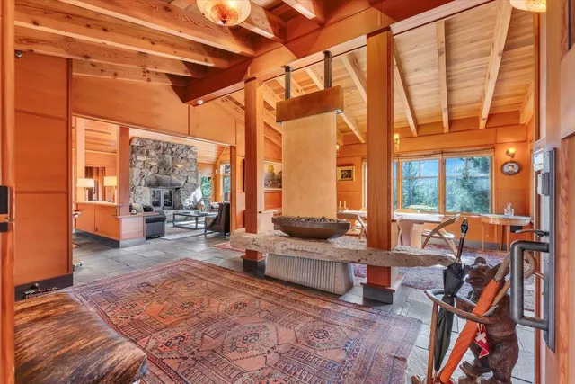 a living room with furniture and a floor to ceiling window