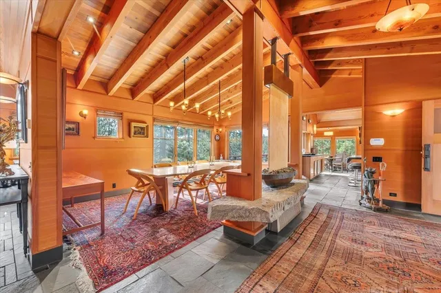 a outdoor space with lots of tables a large mirror and a couch