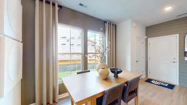 a living room with stainless steel appliances furniture and a view of kitchen
