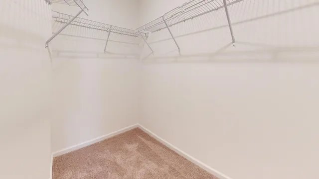 a living room with furniture and a book shelf