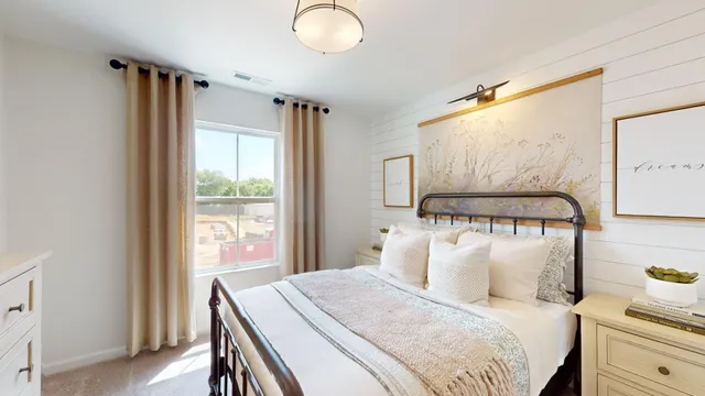 a bedroom with a bed and a lamp