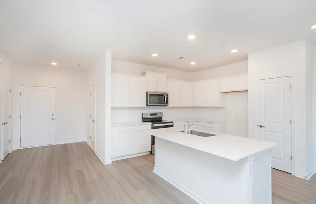a kitchen with stainless steel appliances a refrigerator and a stove top oven