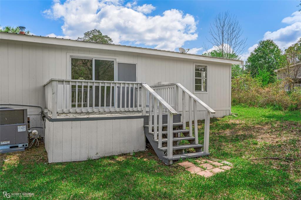 224 Prysock Road Doyline, LA 71023 - Photo 20 of 34 a view of a house with a yard and deck