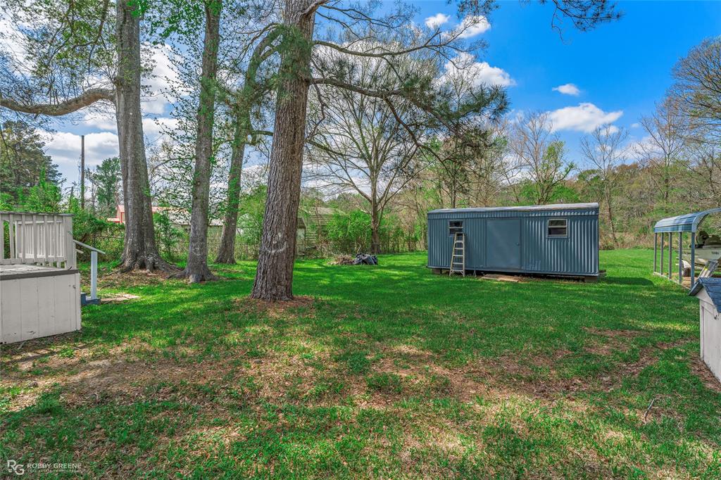 224 Prysock Road Doyline, LA 71023 - Photo 24 of 34 a view of a backyard with large trees and wooden fence