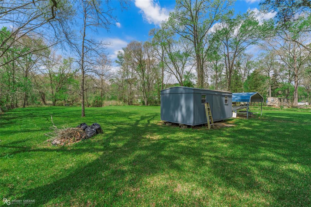 224 Prysock Road Doyline, LA 71023 - Photo 25 of 34 a backyard of a house with table and chairs