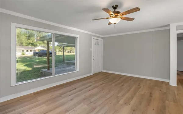 wooden floor in an empty room with a window