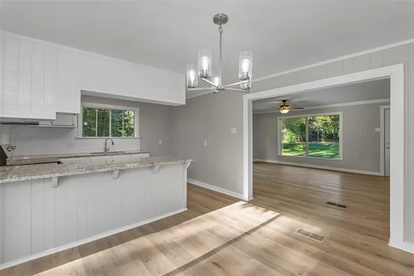 a view of a kitchen with a sink stainless steel appliances and cabinets