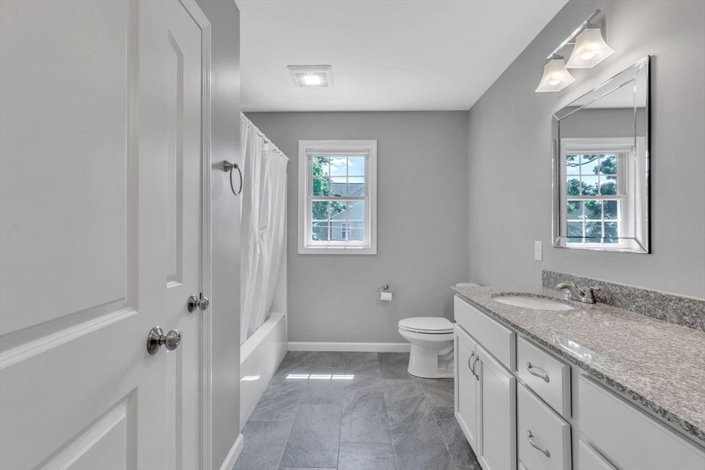 30 Irvington Street Springfield, MA 01108 - Photo 30 of 42 a bathroom with a granite countertop sink toilet and shower