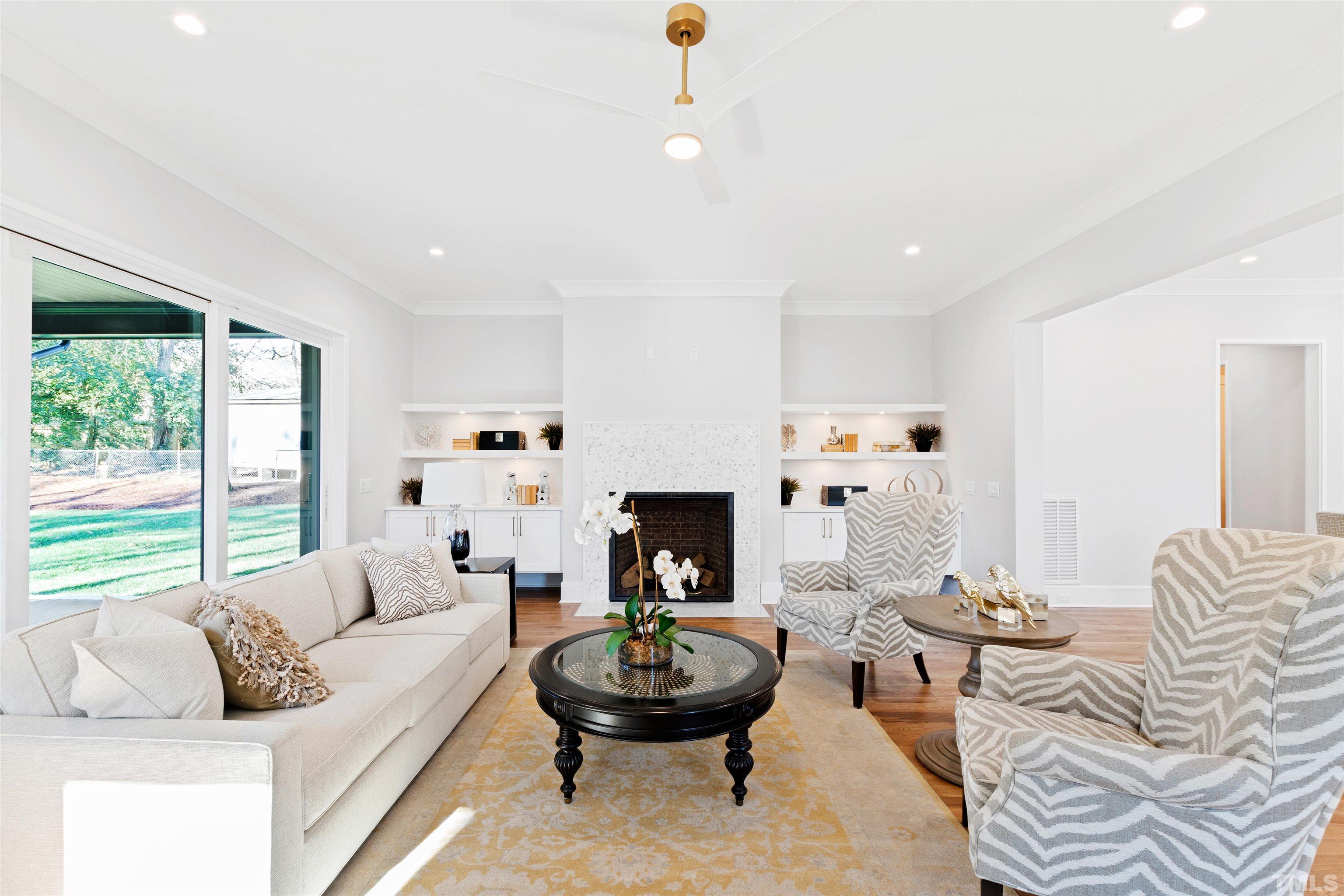 604 Yale Street Raleigh, NC 27609 - Photo 25 of 74 a living room with furniture a fireplace and a large window