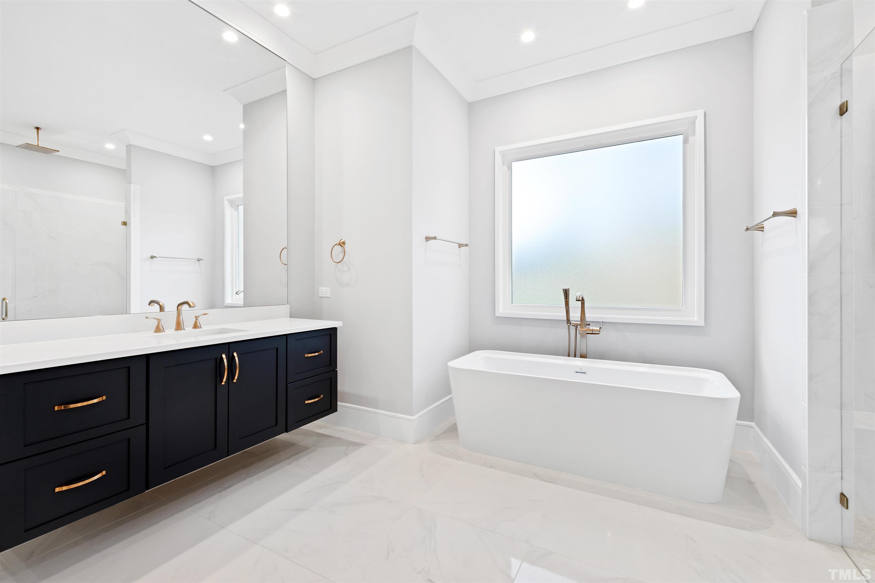 604 Yale Street Raleigh, NC 27609 - Photo 35 of 74 a spacious bathroom with a double vanity sink mirror and bathtub