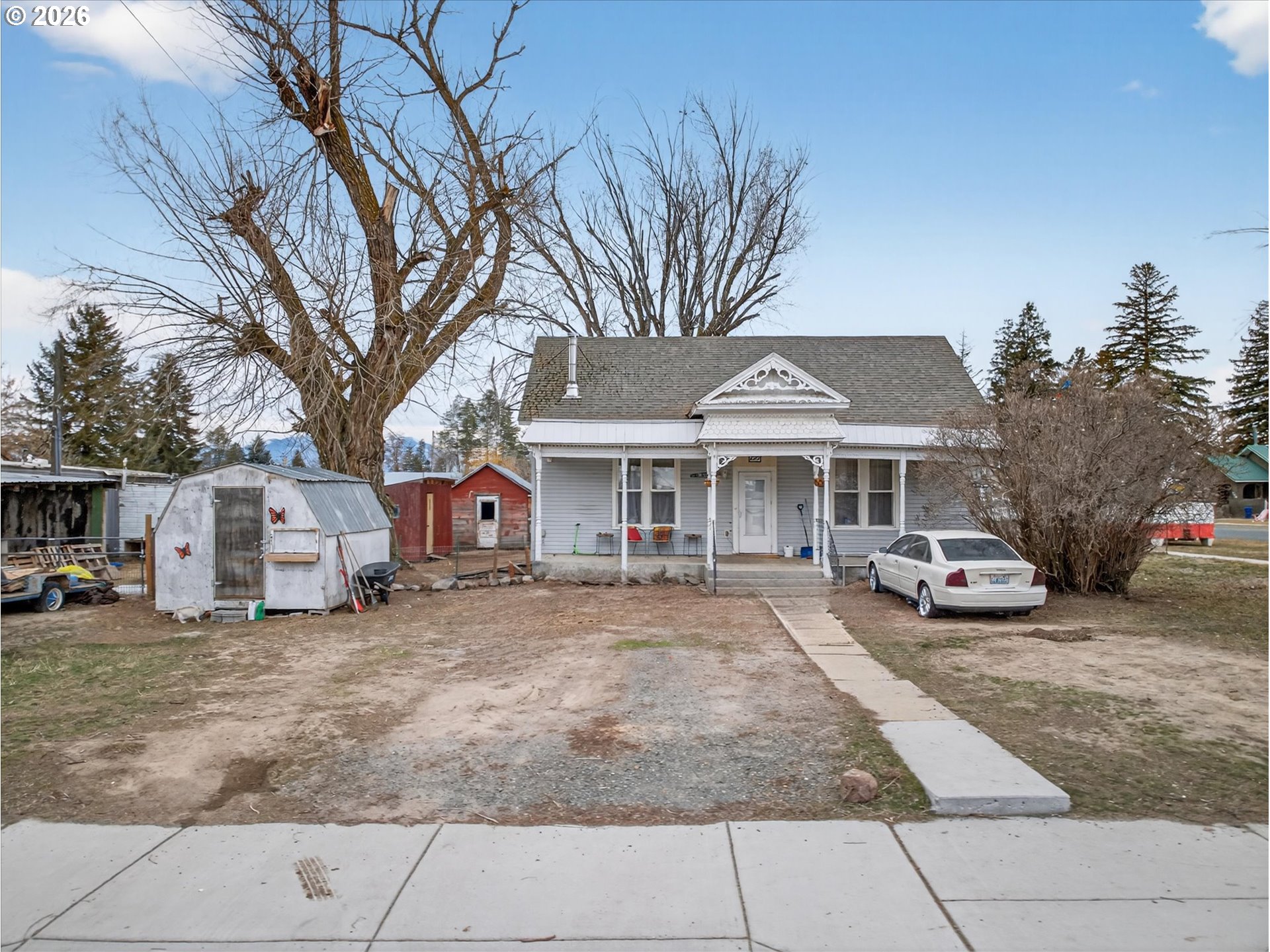a front view of a house with cars parked