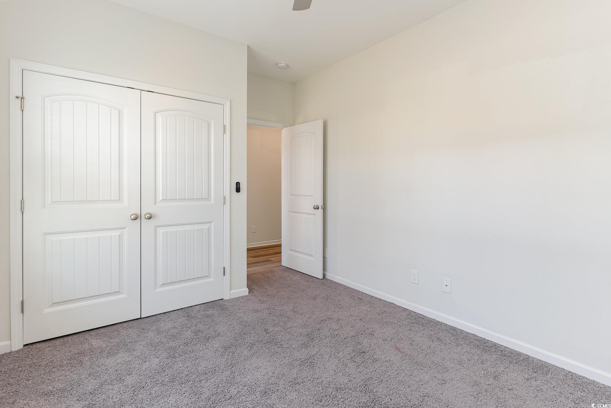 577 Rycola Circle Surfside Beach, SC 29575 - Photo 16 of 28 Unfurnished bedroom featuring a ceiling fan, a clo