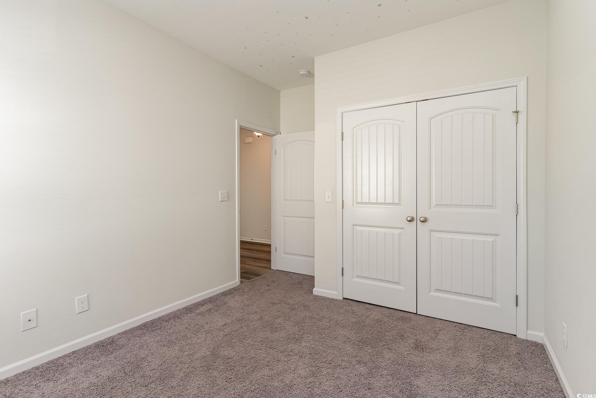 577 Rycola Circle Surfside Beach, SC 29575 - Photo 18 of 28 Unfurnished bedroom with baseboards, a closet, and