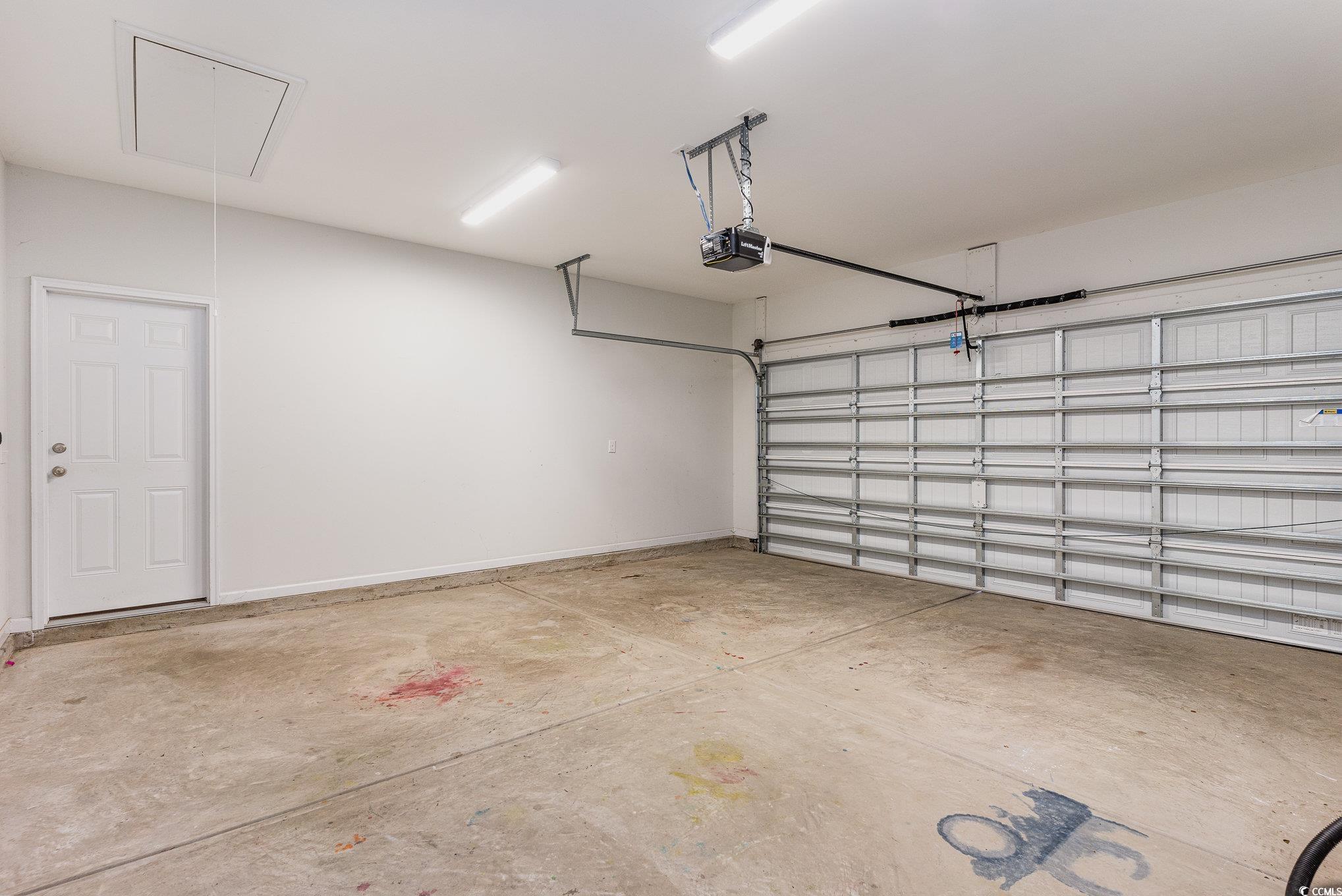 577 Rycola Circle Surfside Beach, SC 29575 - Photo 21 of 28 Garage featuring a garage door opener and baseboar
