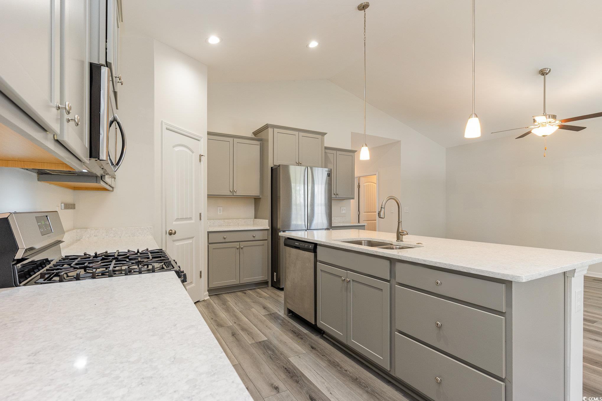 577 Rycola Circle Surfside Beach, SC 29575 - Photo 5 of 28 Kitchen featuring gray cabinetry, a sink, hanging
