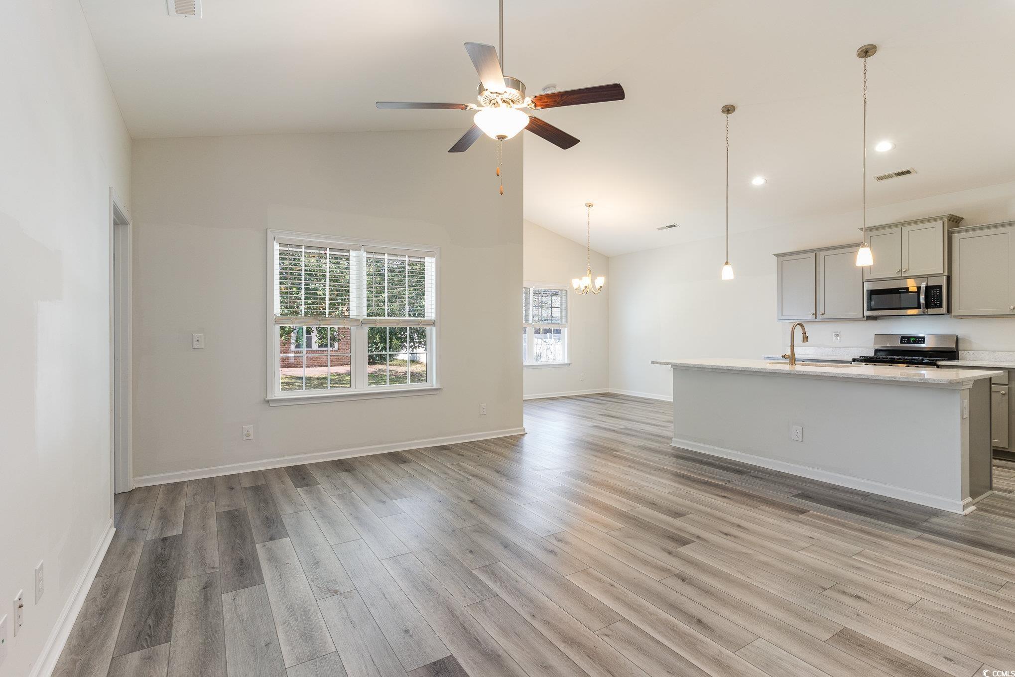 577 Rycola Circle Surfside Beach, SC 29575 - Photo 9 of 28 Unfurnished living room featuring ceiling fan with
