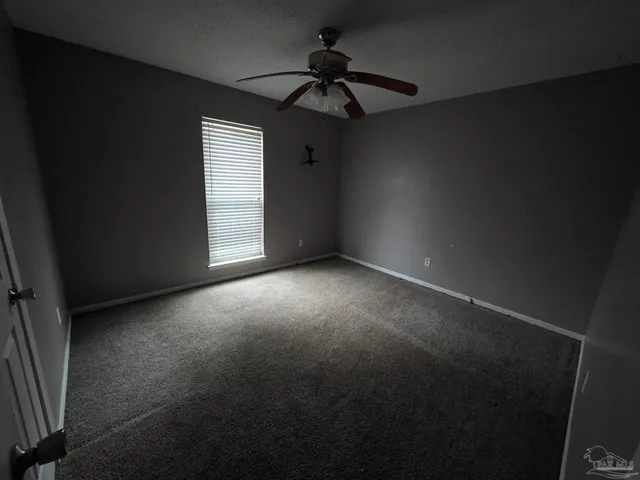 a view of empty room with ceiling fan