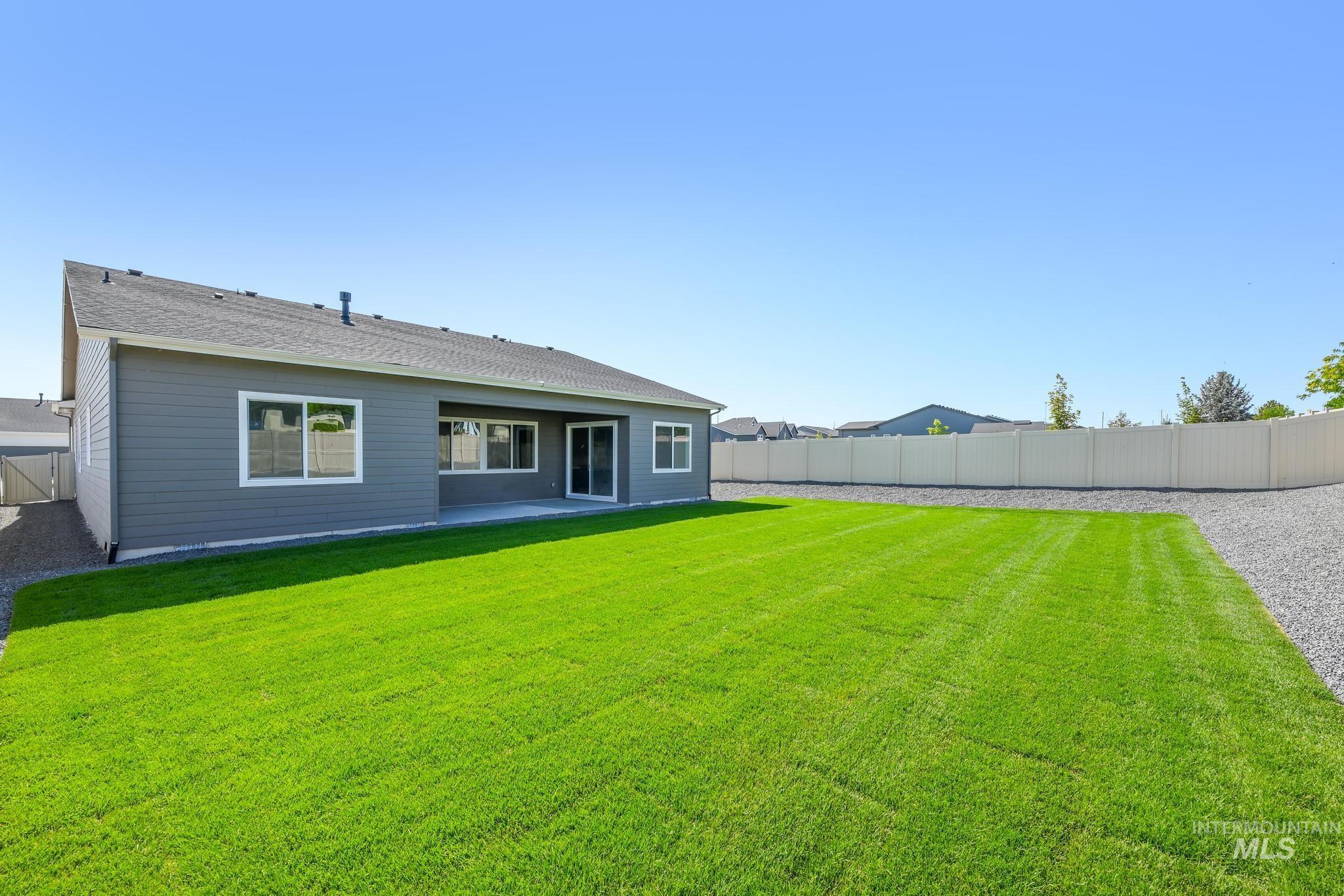 5416 Sparky Avenue Caldwell, ID 83607 - Photo 27 of 42 Back of property with a fenced backyard and a patio area