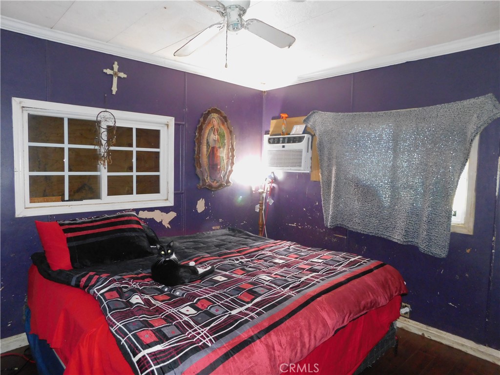 1097 North State Street, Unit 557 Hemet, CA 92543 - Photo 16 of 18 a bed sitting in a bedroom next to a window