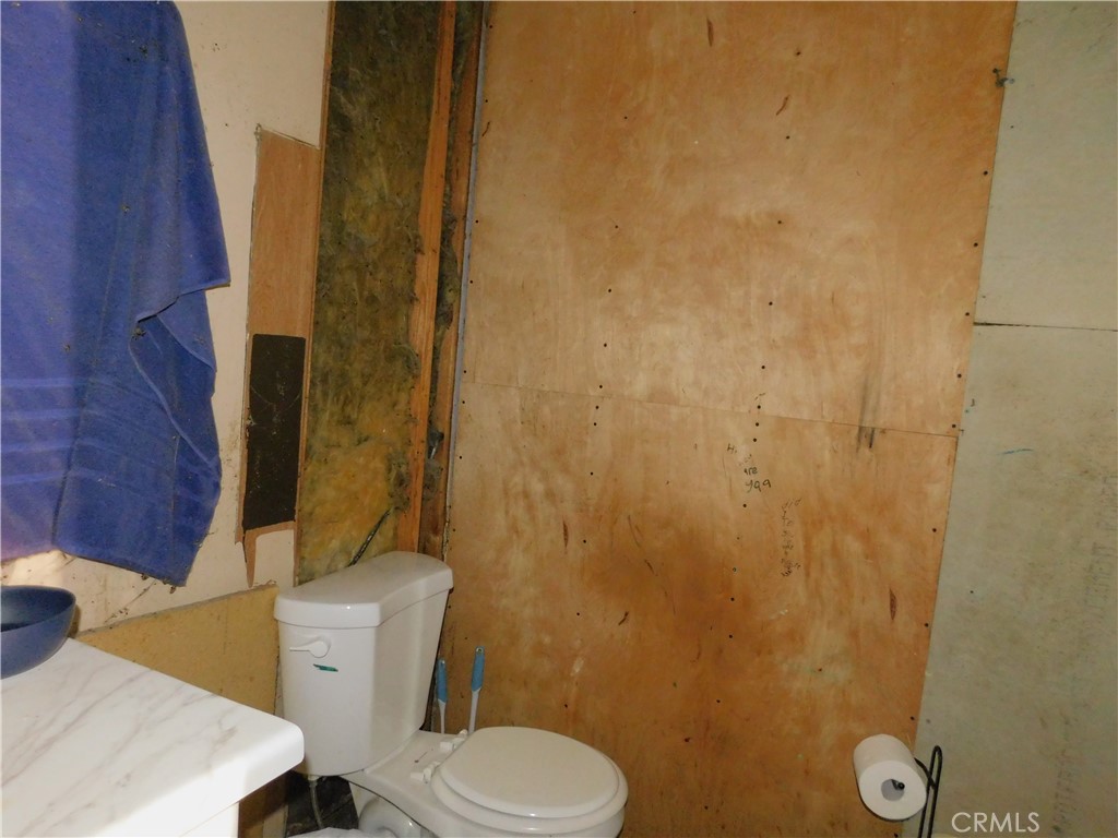 1097 North State Street, Unit 557 Hemet, CA 92543 - Photo 18 of 18 a white toilet sitting next to a shower curtain