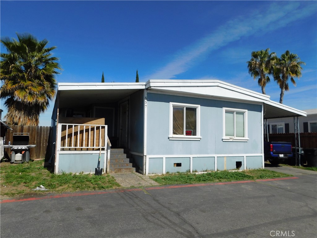 1097 North State Street, Unit 557 Hemet, CA 92543 - Photo 3 of 18 a front view of a house with a yard