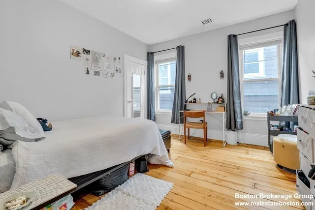 a bedroom with a bed a table and chair