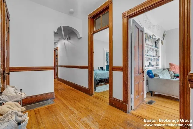 a view of a room with wooden floor and furniture