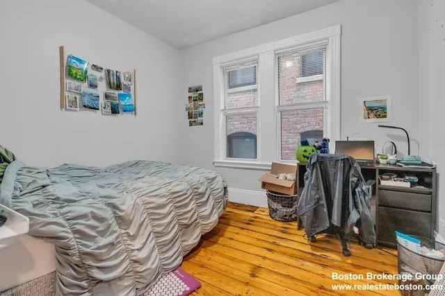 a bedroom with furniture and a wooden floor