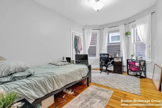 a bedroom with a bed a couch and dresser