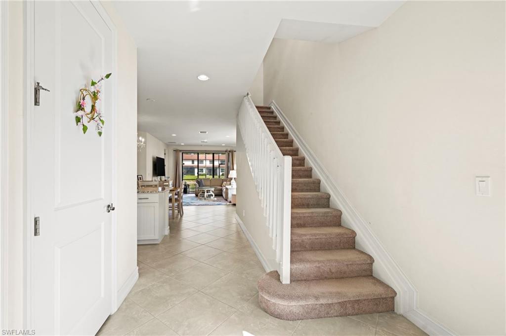 7766 Bristol Circle Naples, FL 34120 - Photo 18 of 30 Staircase featuring tile patterned flooring, baseboards, and recessed lighting