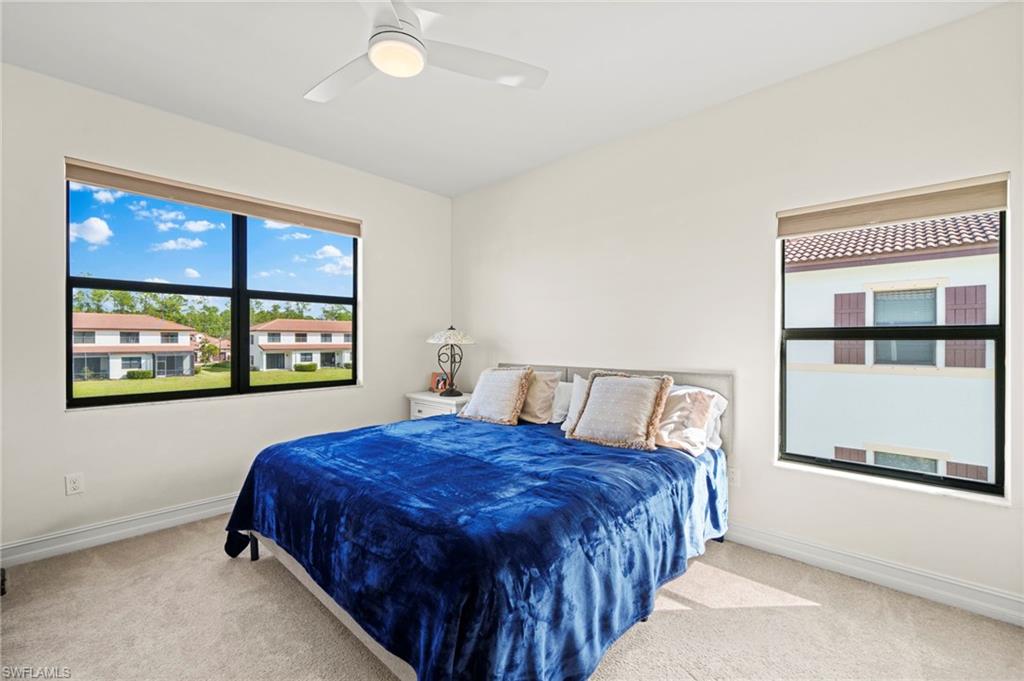 7766 Bristol Circle Naples, FL 34120 - Photo 19 of 30 Carpeted bedroom featuring ceiling fan and baseboards