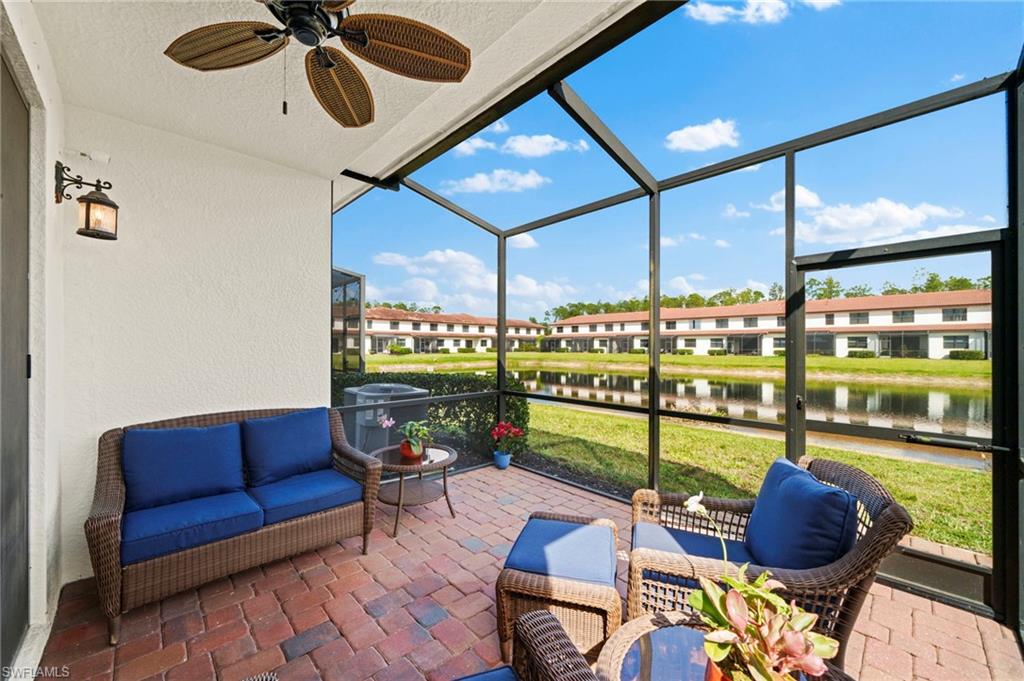 7766 Bristol Circle Naples, FL 34120 - Photo 27 of 30 Sunroom / solarium featuring ceiling fan and a water view
