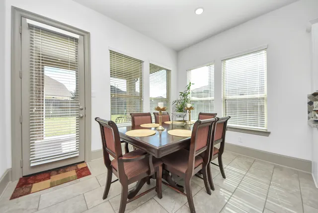 a dining room with furniture and windows