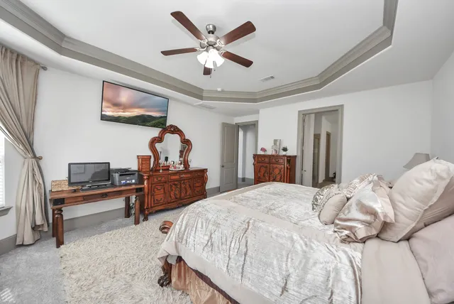 a bedroom with a bed and a chandelier