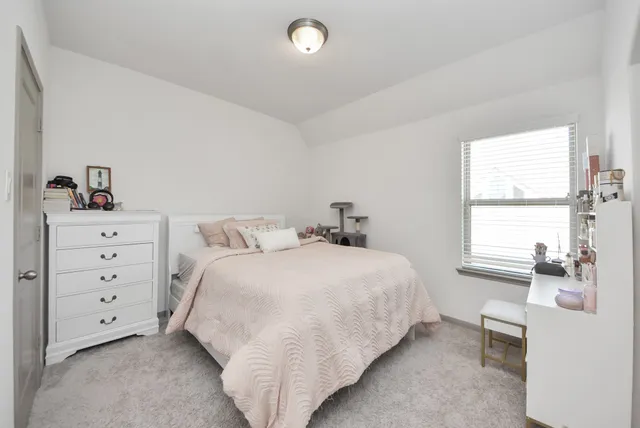 a bedroom with a bed and window