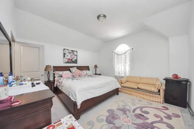 a bedroom with a bed and a couch