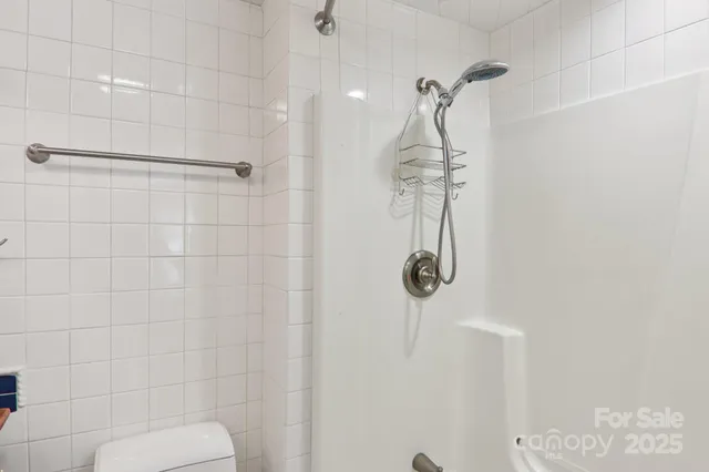 a bedroom with a bed and large windows