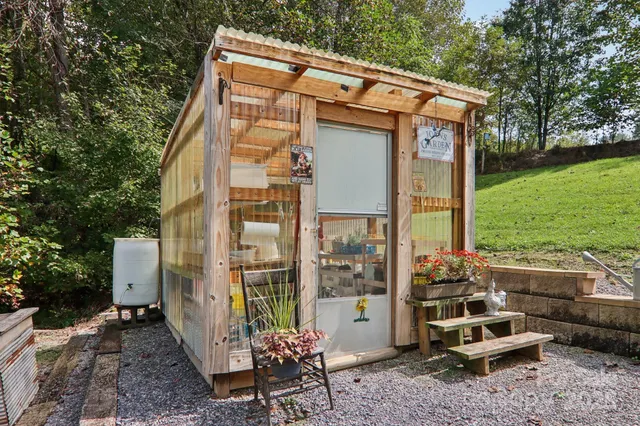 a backyard of a house with table and chairs