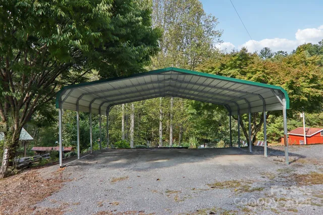a view of a yard with large trees