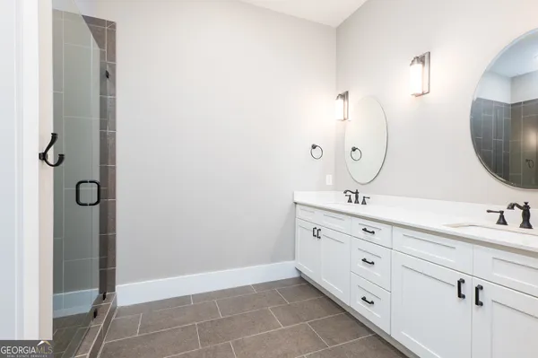 a bathroom with a double vanity sink mirror and