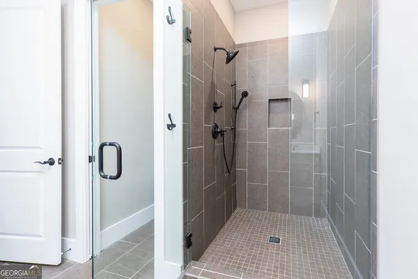 a bathroom with a glass shower door