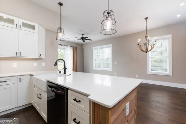 a view of a kitchen sink and chandelier