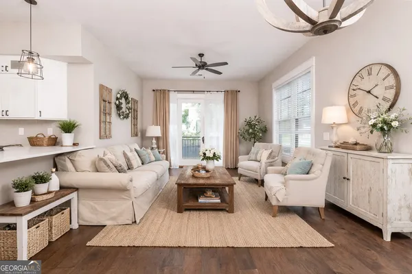 a living room with furniture chandelier and a window