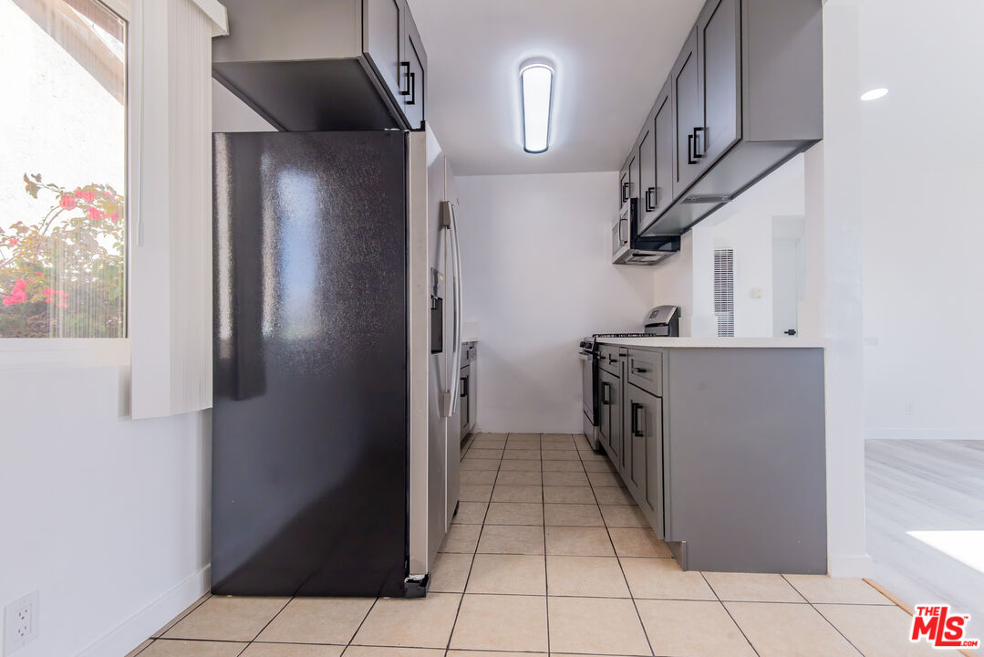 2107 Pullman Lane, Unit D Redondo Beach, CA 90278 - Photo 11 of 32 a kitchen with a refrigerator and a sink