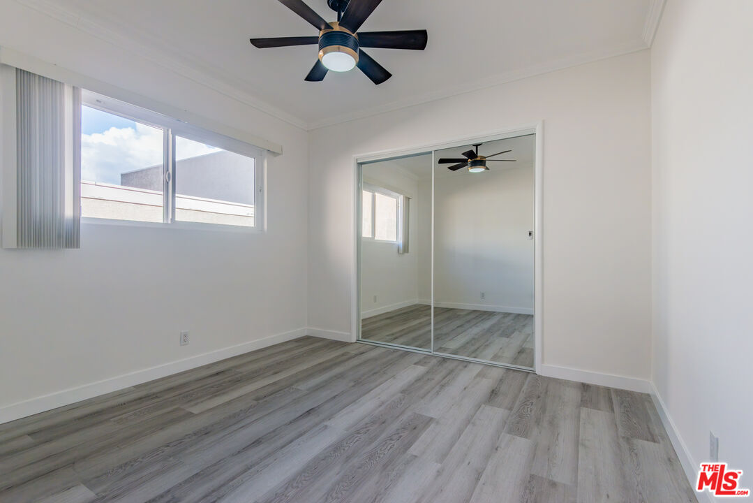 2107 Pullman Lane, Unit D Redondo Beach, CA 90278 - Photo 12 of 32 wooden floor in an empty room with a window