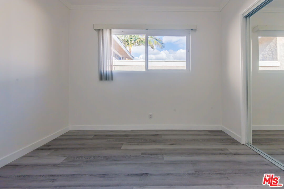 2107 Pullman Lane, Unit D Redondo Beach, CA 90278 - Photo 15 of 32 wooden floor in an empty room with a window
