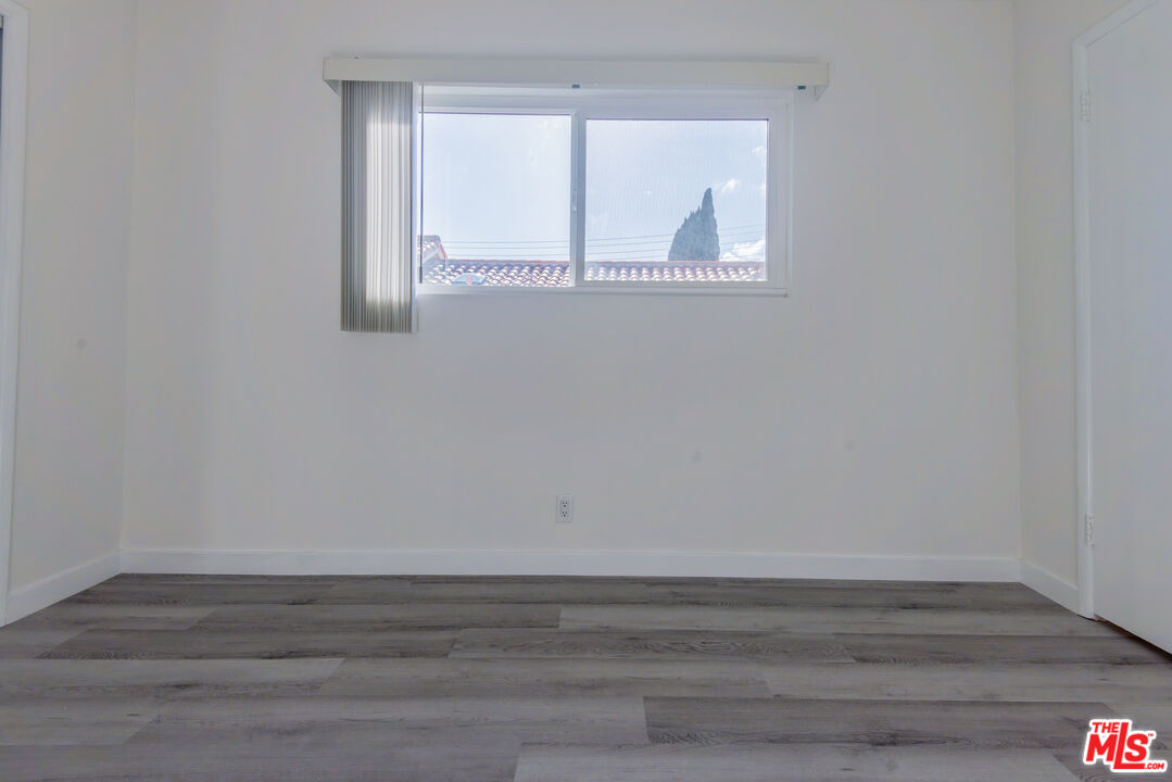 2107 Pullman Lane, Unit D Redondo Beach, CA 90278 - Photo 17 of 32 a view of a small space with wooden floor and a window