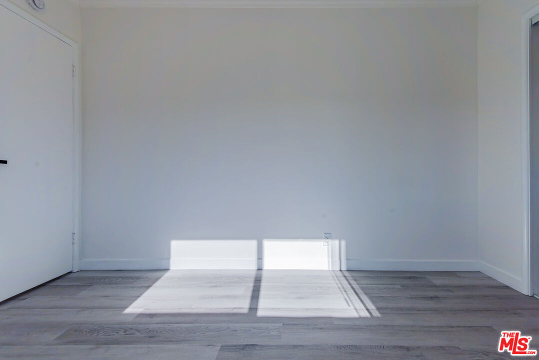 2107 Pullman Lane, Unit D Redondo Beach, CA 90278 - Photo 26 of 32 a view of an empty room and wooden floor